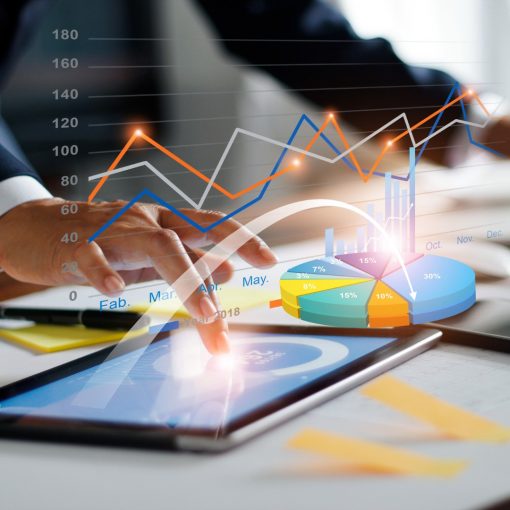 businessman-using-tablet-and-laptop-analyzing-sales-data-and-economic-picture-id1165055244